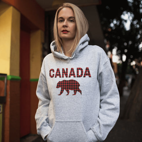 Meet the Plaid & Proud Hoodie, featuring a rugged red & black plaid bear alongside "Canada" in matching plaid lettering—because nothing says “True North strong” like a bear rocking Canadian flannel.